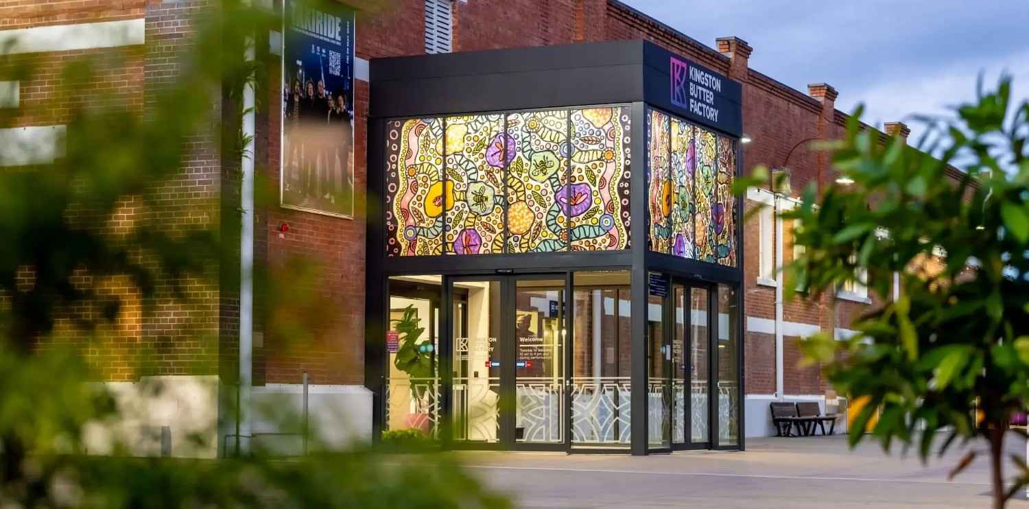 Creative Outpost storefront with colorful stained glass, promoting its reputation strategy services.