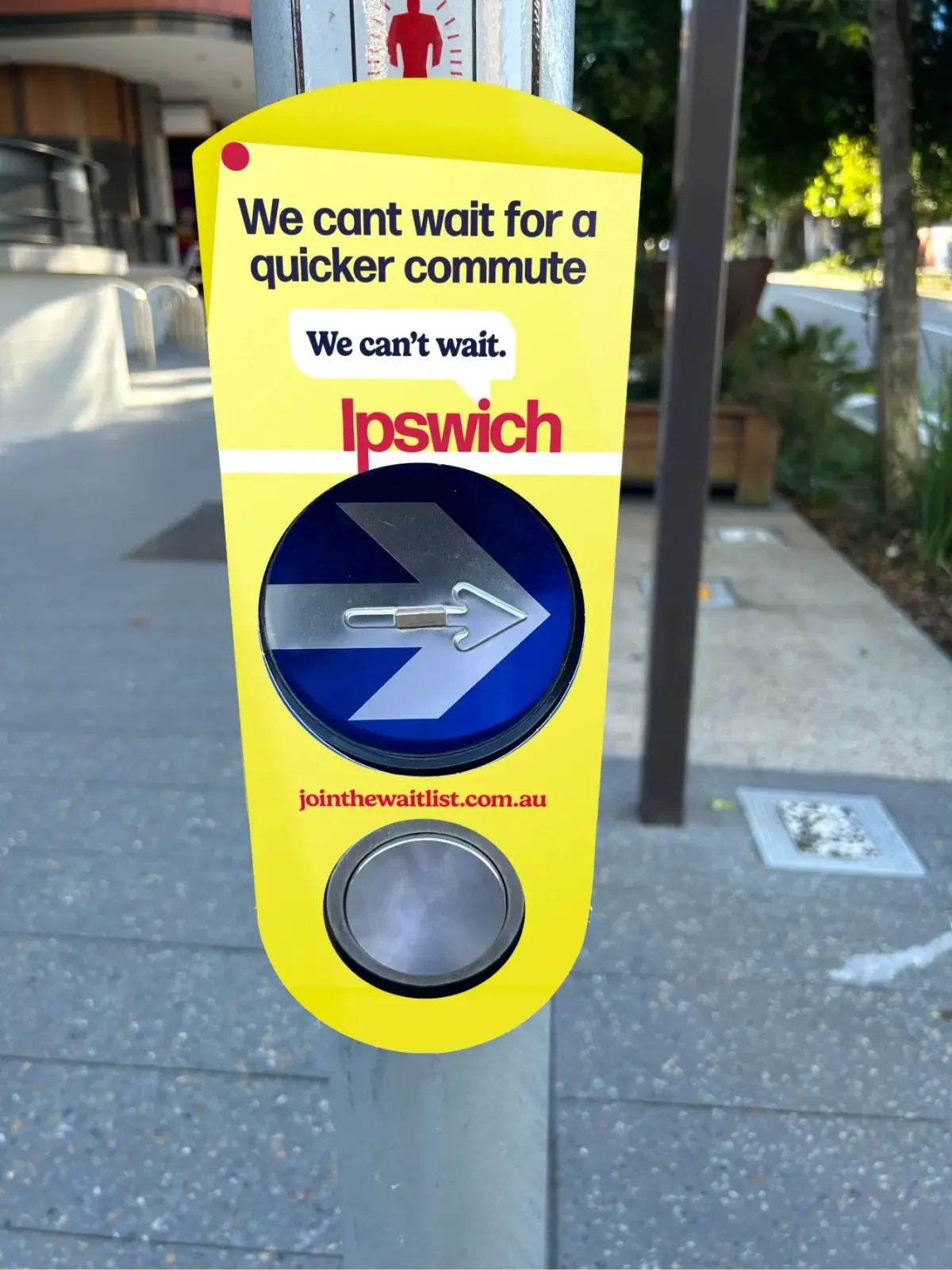 Bright yellow pedestrian signal promoting quicker commutes in Ipswich with an arrow.