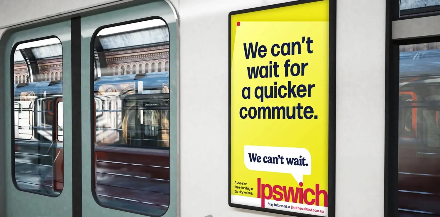 Yellow poster on subway wall promoting quicker commute for Ipswich residents.